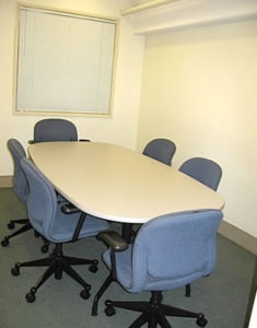Conference room 1 with rectangular table and 6 chairs.